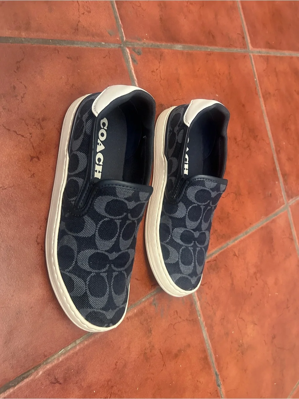 Coach women’s Black Navy Signature Slip-On Sneakers